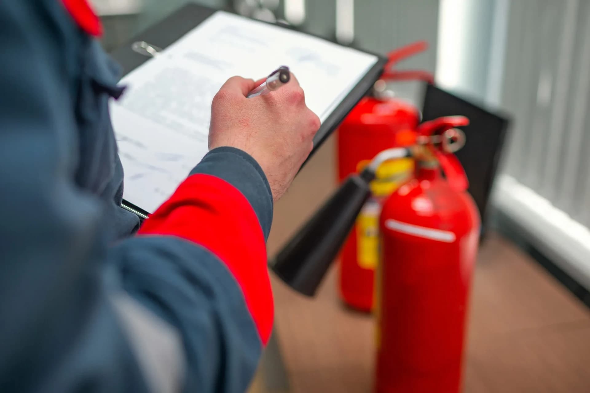 Safety consultant recording fire safety equipment